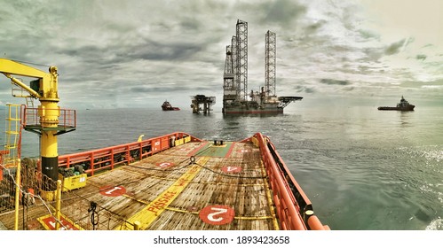 SABAH, MALAYSIA - 10 JUNE 2020, Offshore marine crew stand by on deck during cargo transfer from vessel to oil platform at sea 
