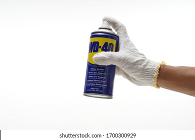 Sabah,Malaysia. February 2020. Hand Holding WD- 40 Or Rust Removal Spray Isolated White Background. 