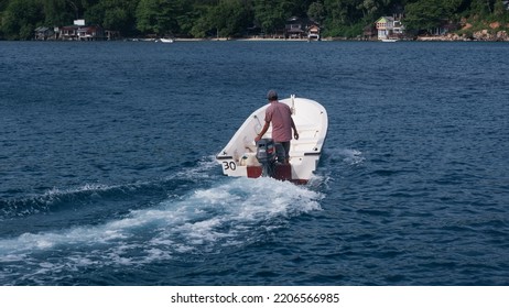 Sabang, Indonesia - July 30, 2022: A Tour Guide Rides His Boat On Rubiah Beach, Sabang