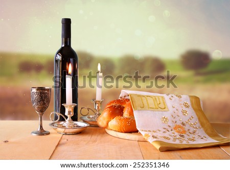 Sabbath image. challah bread, wine and candelas on wooden table. 