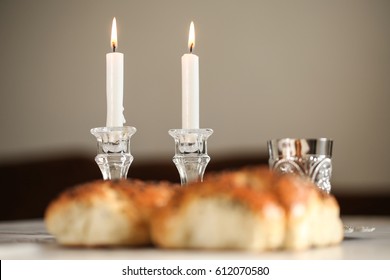  Sabbath image -  Silver kiddush cup, crystal candlesticks with lit candles, and challah challahs

