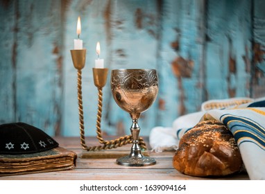 Sabbath Jewish Holiday homemade sesame challah bread and candelas on table