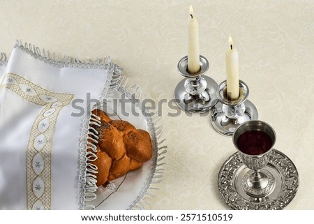 Sabbath Table Setting. Elegant Sabbath table with braided bread, candles, and wine cup.