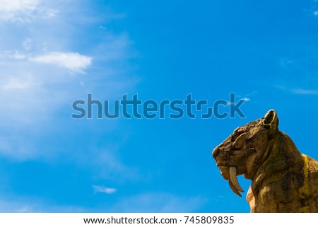Sabertooth tiger statue in the lower right corner and an amazing blue sky