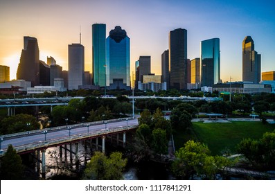 Sabine Street Bridges Over Buffalo Bayou River Houston Texas USA Sunrise Aerial Drone View Golden Hour Ring Around Horizon Y’all Skyscrapers Downtown Skyline Cityscape With Traffic And Highways