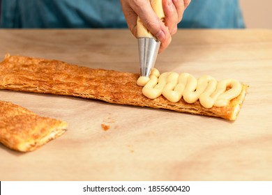 Sac A Poche Pouring Custard On A Layer Of Millefoglie Pastry.