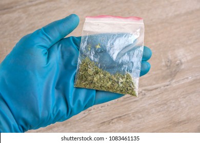 Sachet Of Synthetic Smoking Substance, Cannabis, Weed, Marijuana On The Palm Of A Laboratory Researcher