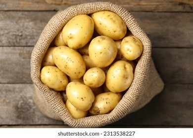 Sack of fresh raw potatoes on wooden background, top view
 - Shutterstock ID 2313538227