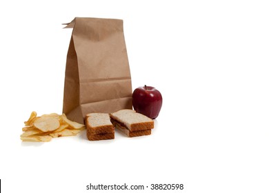 A Sack Lunch With Peanut Butter Sandwich And A Apple