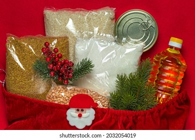 Sack Of Santa Claus With Various Groceries. Cereals, Sunflower Oil, Canned Food. Online Shopping. Flat Lay. Christmas Sale.