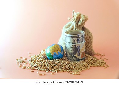 A sack of wheat, spilled, next to a globe, globe and US banknotes. Concept - world food crisis, export, import. The issue of harvest in different countries of the world, the impact of sanctions.