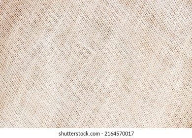 Sackcloth or burlap background with visible texture copy space for text and other web print design elements. Closeup of light natural sackcloth, canvas, fabric, jute, texture pattern for background