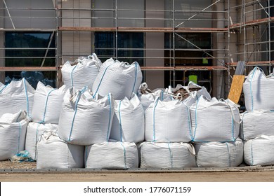 Sacks with construction waste on the street. Construction waste in builders plastic waste bag.