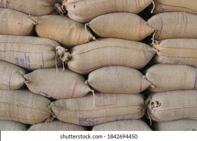 Sacks Full Of Grains In Burlap Bags .Sack Of Grain Are Stacked At A Grain Market In Patiala, India.