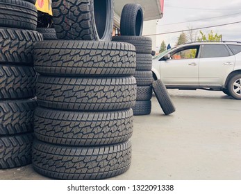 Sacramento, CA - February 24, 2019: Small Tire Shop Exterior With Stacks Of New Tires And Car Waiting To Get New Tires. 