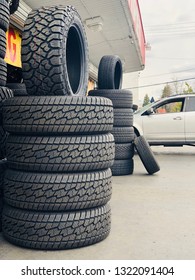 Sacramento, CA - February 24, 2019: Tire Shop With New Tires Outside, Cars Getting Maintenance On New Tires.