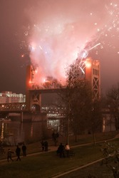 Sacramento, CA - January 1, 2009: Fireworks Exploding Above The Tower Bridge On New Year's Day, As A Celebration. Bridge Is Raised And People Are Watching All Around.