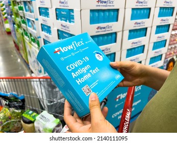 Sacramento, CA, USA March 25th, 2022 Shoppers Hands Holding A Box Containing Flowflex Brand Covid-19 Antigen Home Test At A Local Discount Warehouse Store
