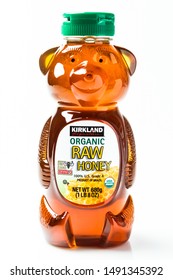 Sacramento, CA/USA 08/25/2019
Plastic bottle of kirkland brand organic raw honey on white background