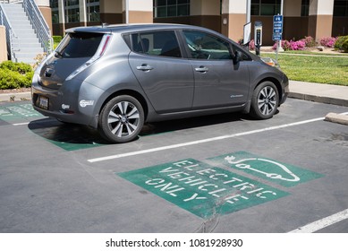 SACRAMENTO, CA/U.S.A. - APRIL 15, 2018: A Photo Of A Silver Nissan Leaf Charging At An Electric Vehicle Station In Sacramento. The State Is Suing The EPA Over Freezing Fuel Economy Standards.