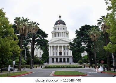 Sacramento, United States / May 23, 2015: The California State Capitol Building, The Home Of The California State Government, With Trees Framing The View And Visitors.