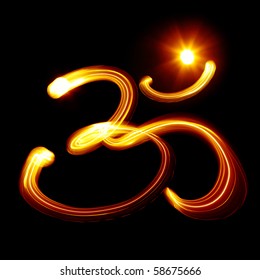Sacred Om syllable created by light over black background