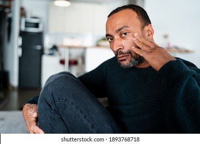 Sad 40 Years Old Man Sitting On The Sofa At Home