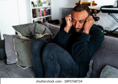 Sad 40 Years Old Man Sitting On The Sofa At Home