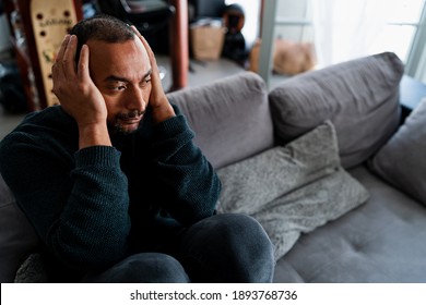 Sad 40 Years Old Man Sitting On The Sofa At Home