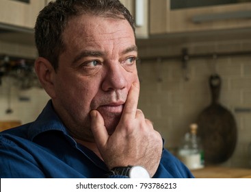 Sad 45-50 Years Old Man In The Interior Of His Room Close-up Portrait