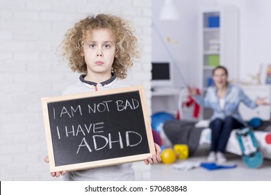 Sad ADHD Boy Holding Small Board, Shouting Mother In Background