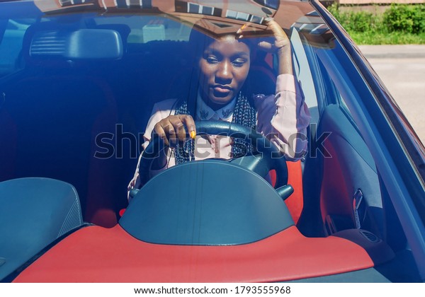 the sad African American\
in the car