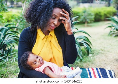 Sad African Woman Holding Her Child And Thinking