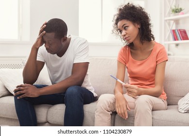 Sad African-american Couple After Pregnancy Test Result, Sitting On Couch At Home, Man Desperate And Depressed, Right Contraception Concept, Copy Space