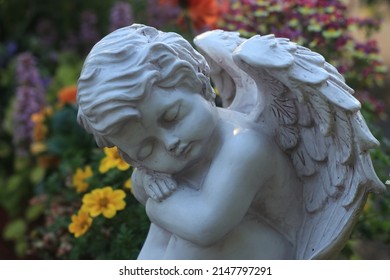 Sad Angel In The Flower Garden