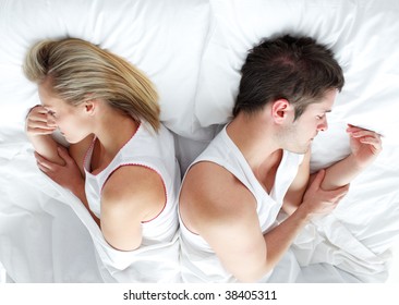 Sad And Angry Couple Lying In Bed Separately After Having An Argument. Marriage Trouble