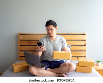 Sad And Angry Face Of Asian Man Is Having A Problem With His Online Store. Concept Of Freelance Startup And Online Business Home Office.