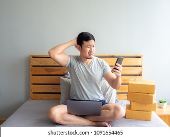 Sad And Angry Face Of Asian Man Is Having A Problem With His Online Store. Concept Of Freelance Startup And Online Business Home Office.