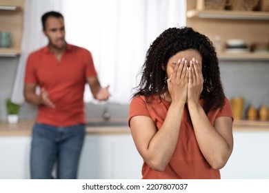 Sad angry millennial black male scolding to crying offended female in kitchen interior, free space. Quarrel, scandal, relationship problems and domestic violence at home during covid-19 pandemic - Shutterstock ID 2207807037