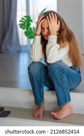 Sad And Angry Teenage Girl Sitting On The Floor In The Room. Teenager Problems Concept