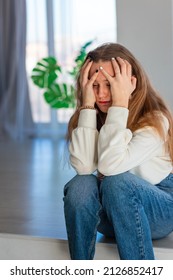 Sad And Angry Teenage Girl Sitting On The Floor In The Room. Teenager Problems Concept