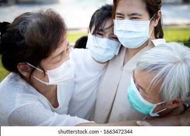 Sad Asian Family Wearing Medical Mask Crying,suffer From Grief,great Loss Of Her Family Infected,fight The Covid-19,Coronavirus Outbreak,people Affected Epidemic Crisis ,hug,comforting,encouragement