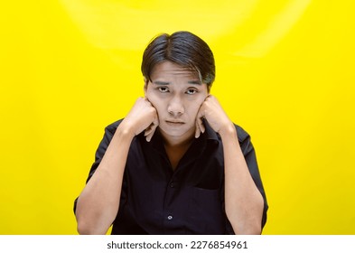 A sad asian man is crying and wiping away tears after having a problems. stressful man cries out loudly. a worker crying after losing his job. - Shutterstock ID 2276854961