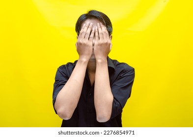 A sad asian man is crying and wiping away tears after having a problems. stressful man cries out loudly. a worker crying after losing his job. - Shutterstock ID 2276854971