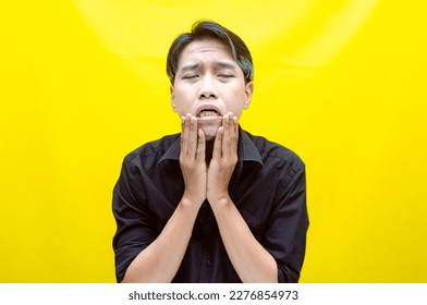 A sad asian man is crying and wiping away tears after having a problems. stressful man cries out loudly. a worker crying after losing his job. - Shutterstock ID 2276854973