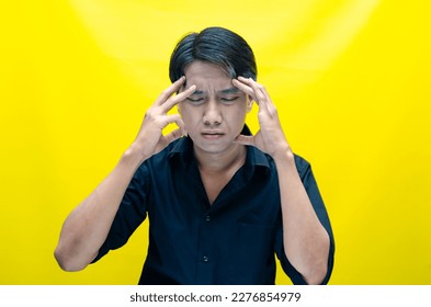 A sad asian man is crying and wiping away tears after having a problems. stressful man cries out loudly. a worker crying after losing his job. - Shutterstock ID 2276854979