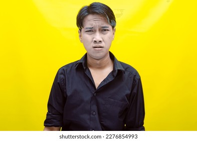 A sad asian man is crying and wiping away tears after having a problems. stressful man cries out loudly. a worker crying after losing his job. - Shutterstock ID 2276854993