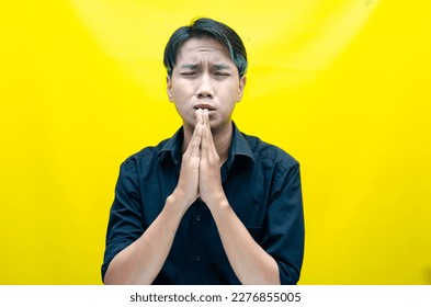 A sad asian man is crying and wiping away tears after having a problems. stressful man cries out loudly. a worker crying after losing his job. - Shutterstock ID 2276855005