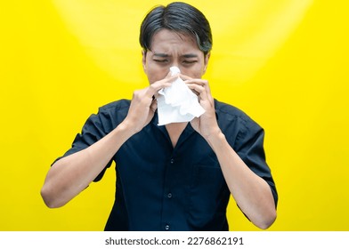 A sad Asian man is crying and wiping away tears after having problems using tissues. After losing his job, a man was seen crying deeply and wiping his tears with tissues.  - Shutterstock ID 2276862191