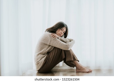 Sad Asian Woman With Depression Sitting Alone On The Floor. Major Depressive Disorder